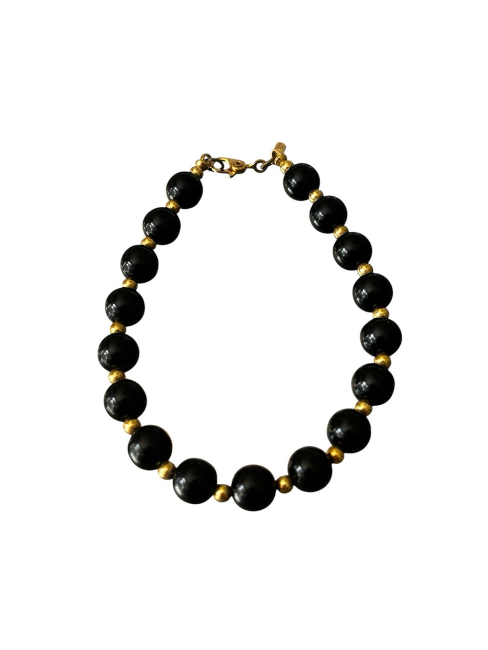 Vintage Monet black and gold tone string beaded bracelet.